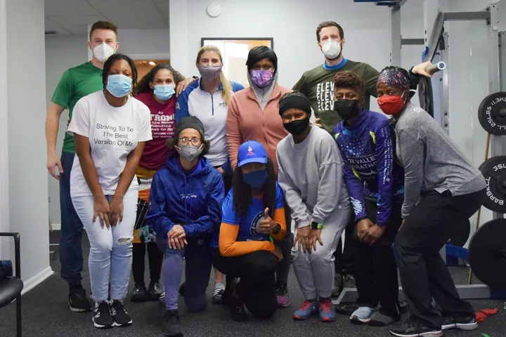 Group photo from an Elevate running clinic in the treatment gym