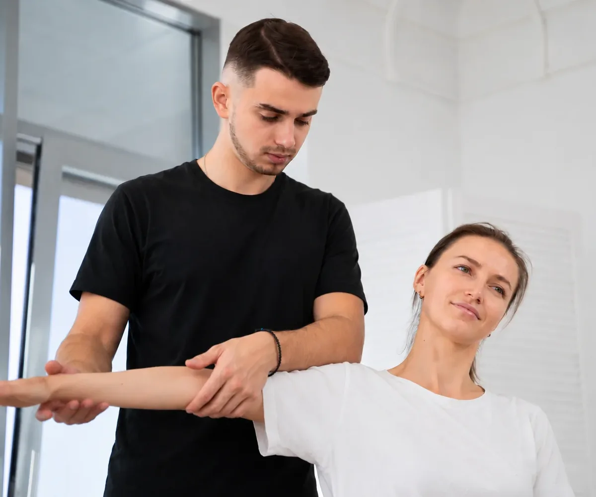 Physical therapist guiding a patient through a hands-on treatment session